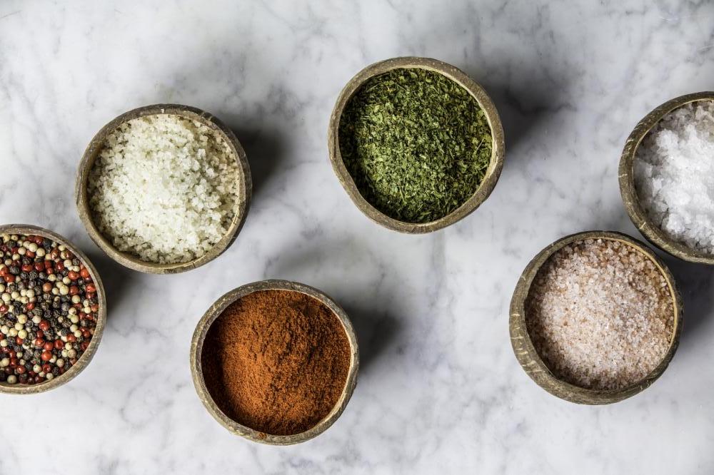 salt and herbs in small bowls